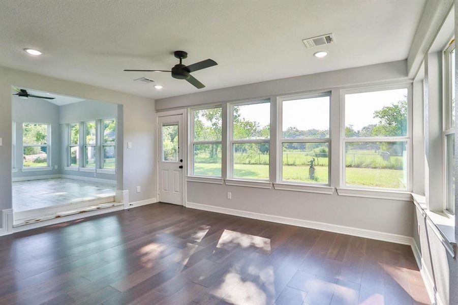 Character, Space And Timeless Elegance. Family room with exterior door the back yard. Step up to the bonus sunroom which could be a dining room, home-office, home-school room or play area for little ones.