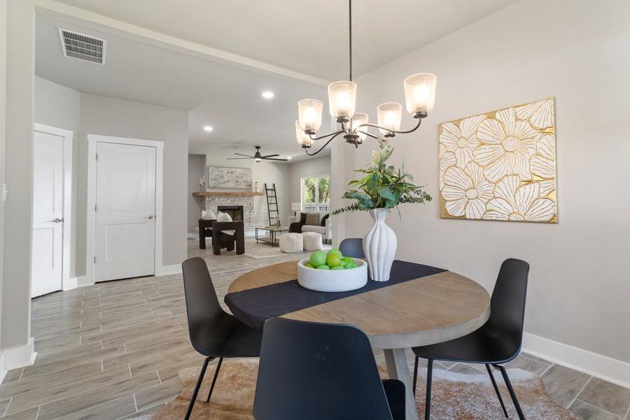 An inviting dining area flows into a comfortable living space, creating a harmonious open-concept design. An inviting dining area flows into a comfortable living space, creating a harmonious open-concept design.