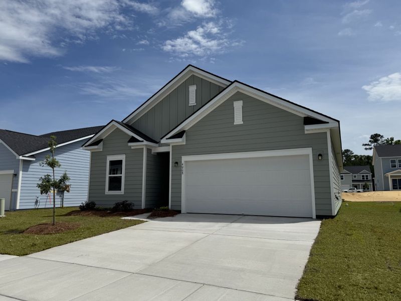 Front exterior of a new home in Tea Farm, Ravenel, SC, highlighting curb appeal (Image 2). Front exterior of a new home in Tea Farm, Ravenel, SC, highlighting curb appeal (Image 2).