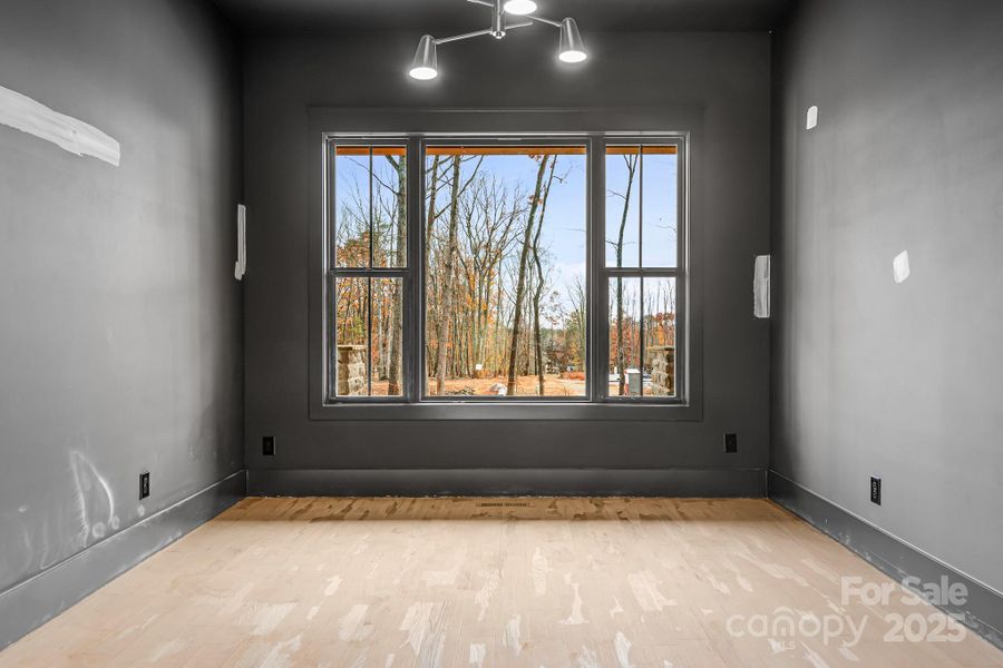 A quiet, moody office with closets overlooking the gorgeous trees out front.