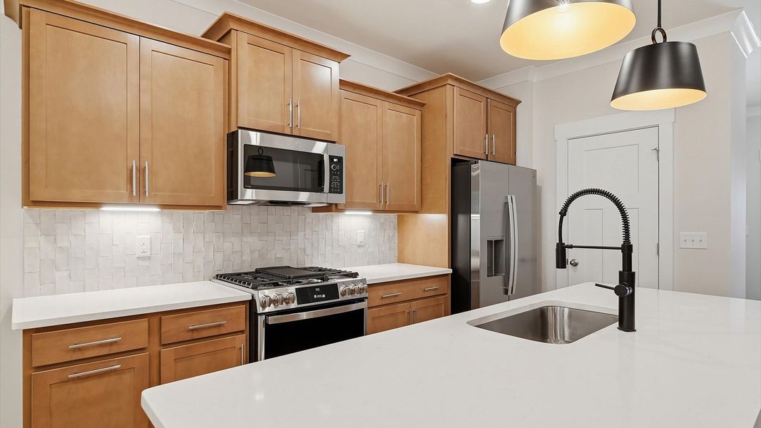 Vibrant kitchen layout with a center island, refined finishes, and open-concept flow Vibrant kitchen layout with a center island, refined finishes, and open-concept flow