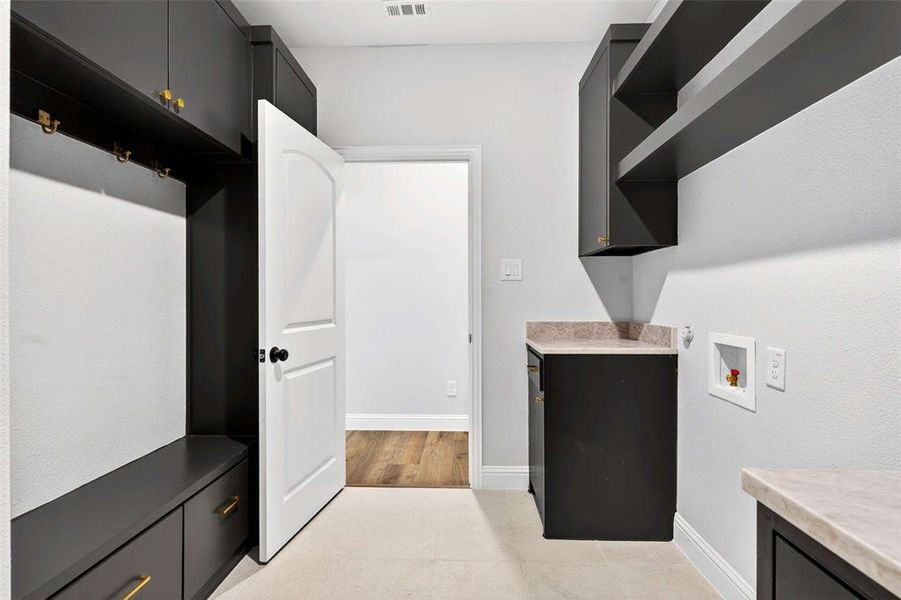 Washroom featuring cabinet space and hookup for a washing machine
