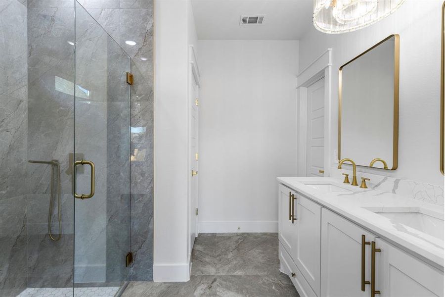 Bathroom featuring vanity and a shower with shower door