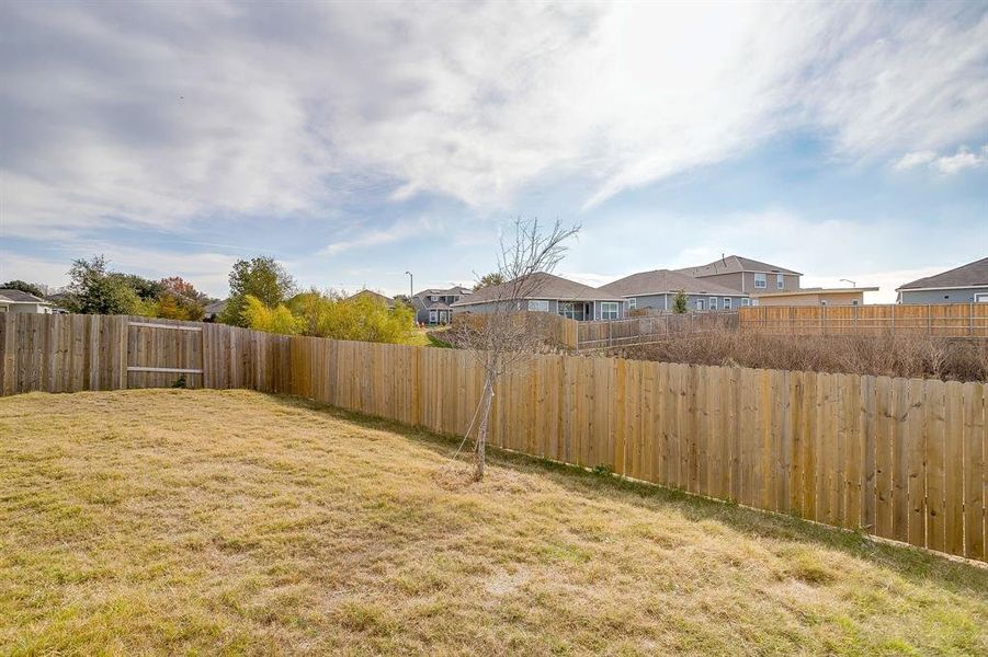 Fenced backyard featuring a residential view