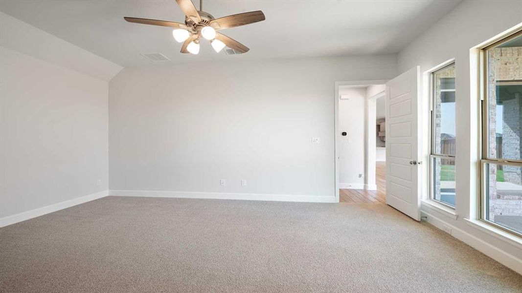 Unfurnished room featuring ceiling fan and light colored carpet