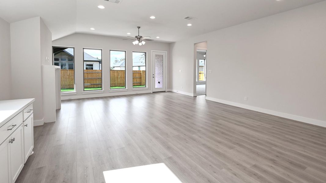 Unfurnished living room with recessed lighting, light wood-type flooring, and ceiling fan Unfurnished living room with recessed lighting, light wood-type flooring, and ceiling fan
