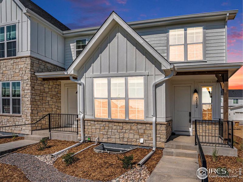 Front exterior of a new home in , Loveland, CO, highlighting curb appeal (Image 1).