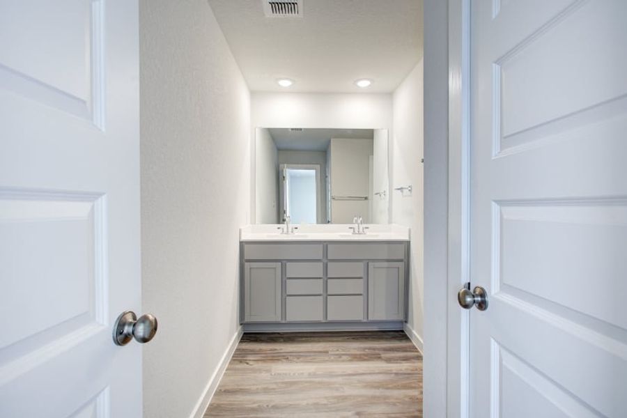 A bathroom with white cabinets. A bathroom with white cabinets.