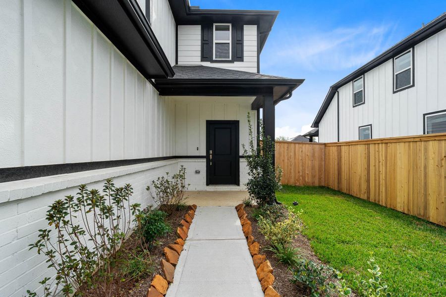 Enjoy a neatly manicured front yard featuring vibrant green grass and easy-to-maintain garden beds guiding you to the inviting covered entrance. Enjoy a neatly manicured front yard featuring vibrant green grass and easy-to-maintain garden beds guiding you to the inviting covered entrance.