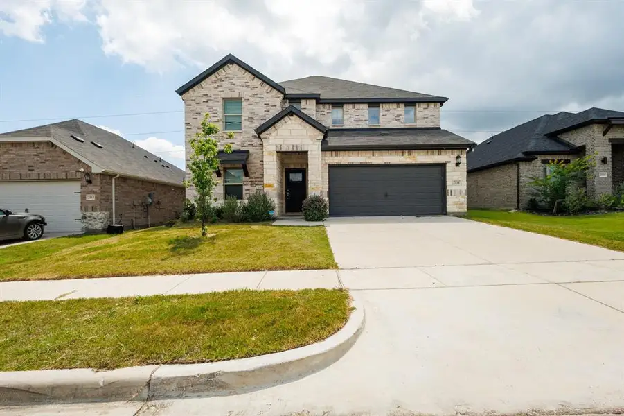 Front exterior of a new home in Stonehaven, Seagoville, TX, highlighting curb appeal (Image 2). Front exterior of a new home in Stonehaven, Seagoville, TX, highlighting curb appeal (Image 2).