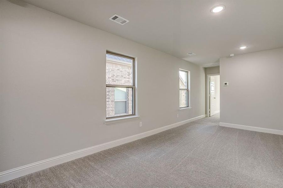 Empty room featuring light colored carpet and recessed lighting Empty room featuring light colored carpet and recessed lighting
