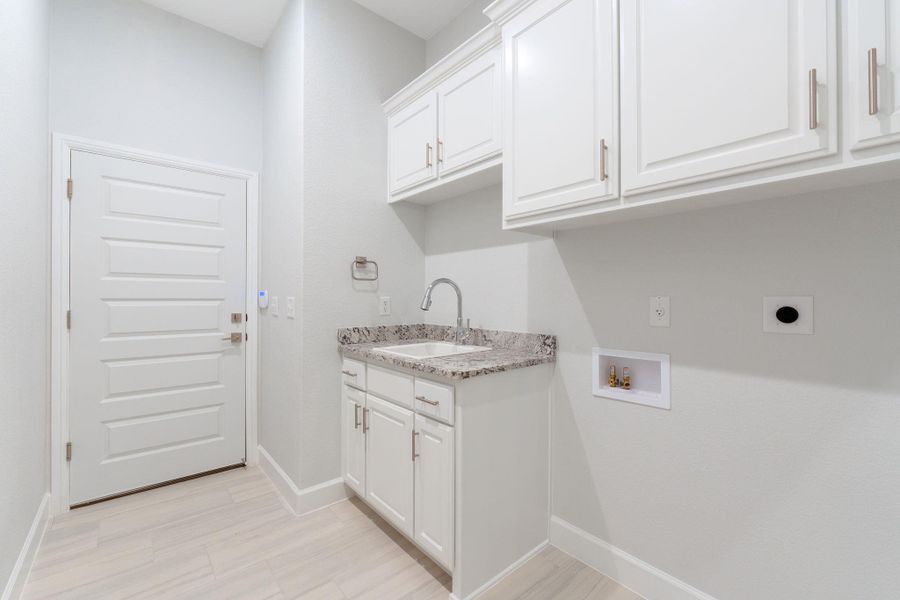 Laundry area featuring cabinet space, washer hookup, and electric dryer hookup