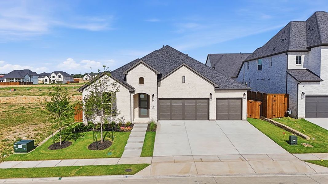 Front exterior of a new home in Custer Ridge Estates, Allen, TX, highlighting curb appeal (Image 2). Front exterior of a new home in Custer Ridge Estates, Allen, TX, highlighting curb appeal (Image 2).