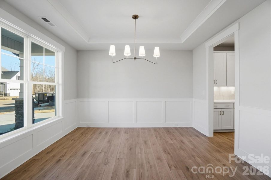 Dining room with Craftsman-style trim and tray ceiling