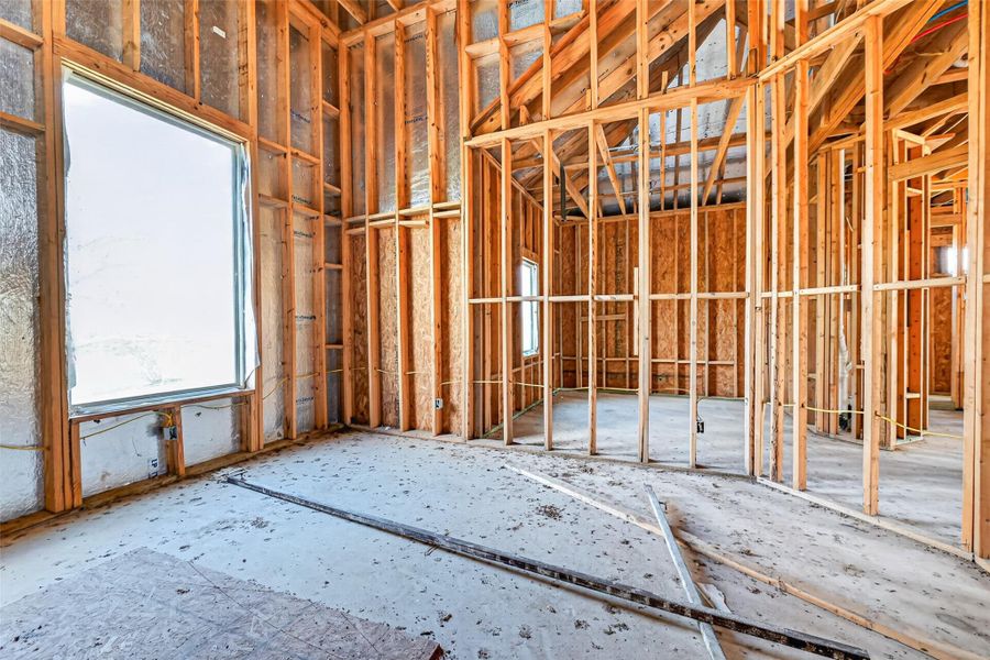 Open unfinished space showcasing framing and build progress.