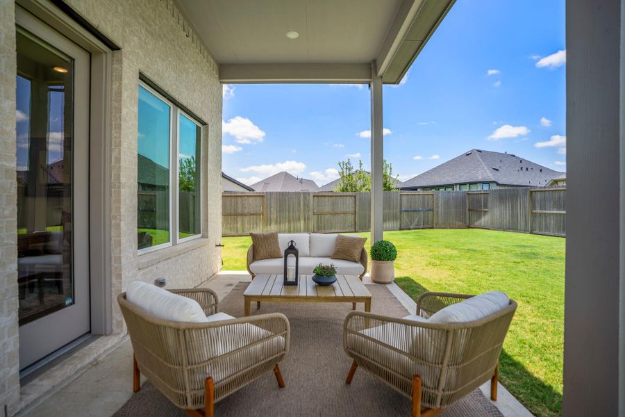 This covered patio creates an easy outdoor extension of the home, with plenty of room to relax, visit with friends or enjoy a quiet morning while overlooking the spacious fenced backyard.