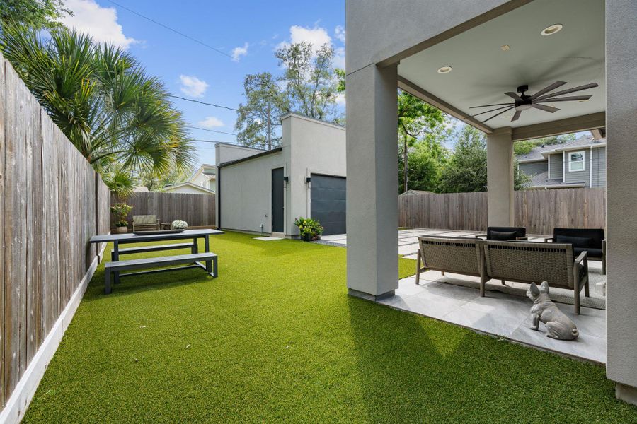 Another view of the turfed backyard highlights the covered patio and generous green space.