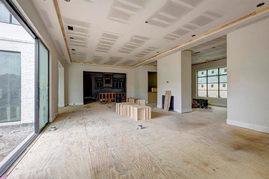 Spacious living room with fireplace has access to the pool area through the large glass sliding doors. Stage of construction as of April 3, 2025. Spacious living room with fireplace has access to the pool area through the large glass sliding doors. Stage of construction as of April 3, 2025.