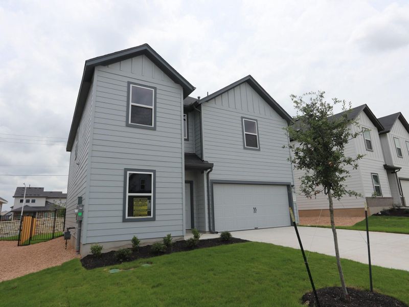 Front exterior of a new home in Cascades at Onion Creek, Austin, TX, highlighting curb appeal (Image 12). Front exterior of a new home in Cascades at Onion Creek, Austin, TX, highlighting curb appeal (Image 12).