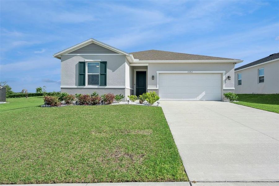Front exterior of a new home in , Mascotte, FL, highlighting curb appeal (Image 21).