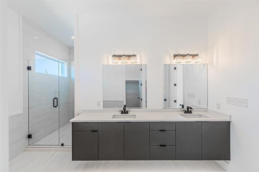 Bathroom with double vanity and a shower stall
