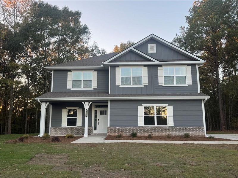 Front exterior of a new home in The Fields of Walnut Creek, Pendergrass, GA, highlighting curb appeal (Image 1). Front exterior of a new home in The Fields of Walnut Creek, Pendergrass, GA, highlighting curb appeal (Image 1).