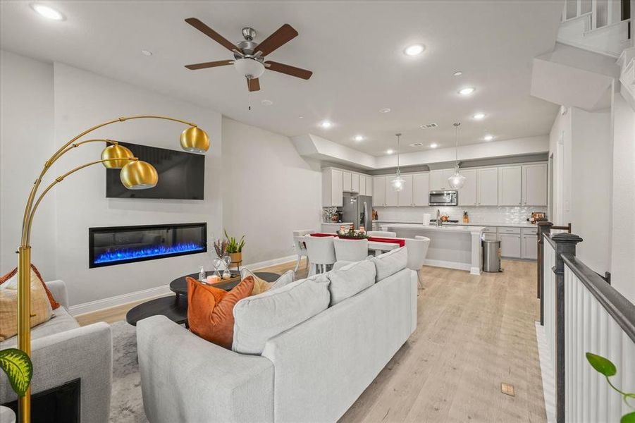 Living room featuring light hardwood / wood-style flooring and ceiling fan