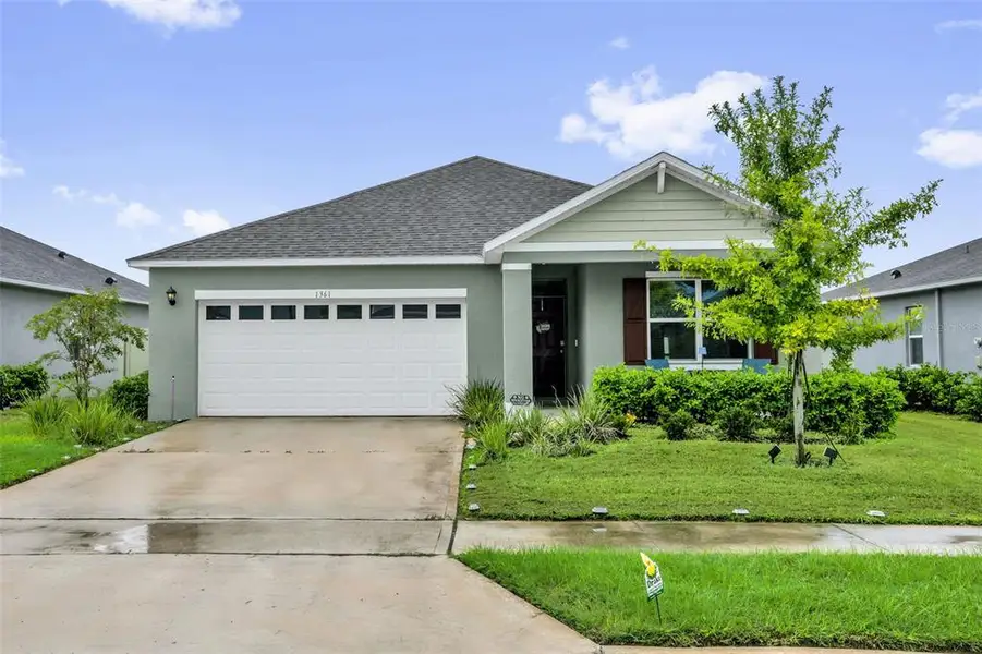 Front exterior of a new home in Timberwalk, Mount Dora, FL, highlighting curb appeal (Image 21).