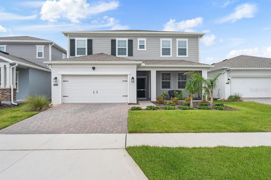 Front exterior of a new home in Wellness Ridge, Clermont, FL, highlighting curb appeal (Image 20). Front exterior of a new home in Wellness Ridge, Clermont, FL, highlighting curb appeal (Image 20).