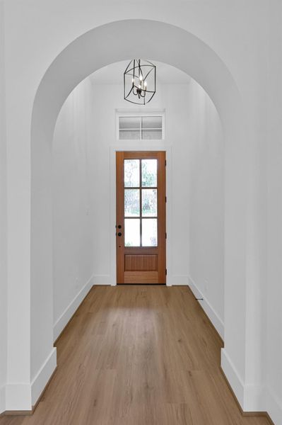 8' wood door and subtle archways to invite you in.