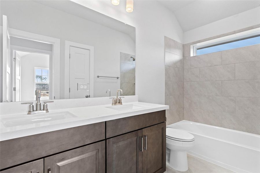 Maximize functionality and reduce morning congestion with this bright secondary bathroom, featuring an invaluable dual vanity sink setup that every family will appreciate. The practical combination of a shower and tub is ideal for both quick showers and relaxing baths for children or guests. Maximize functionality and reduce morning congestion with this bright secondary bathroom, featuring an invaluable dual vanity sink setup that every family will appreciate. The practical combination of a shower and tub is ideal for both quick showers and relaxing baths for children or guests.