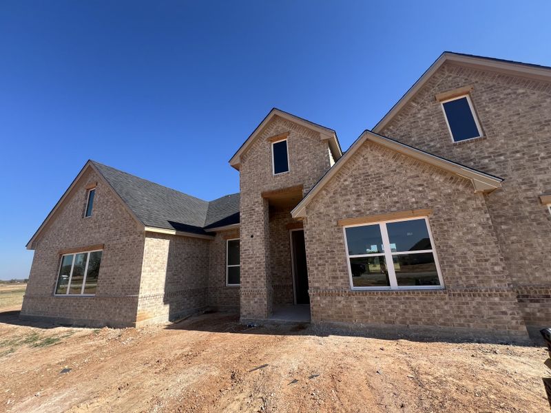 Front exterior of a new home in Zion Valley, Poolville, TX, highlighting curb appeal (Image 2).