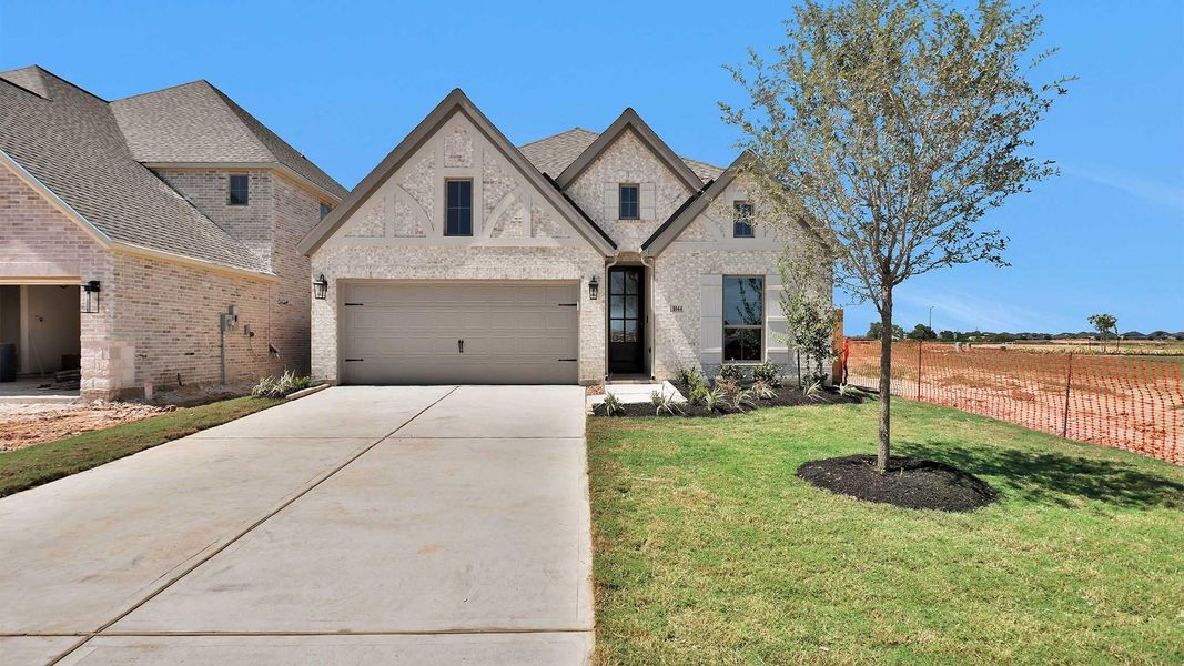 Front exterior of a new home in Lakes of Cane Island, Katy, TX, highlighting curb appeal (Image 2).
