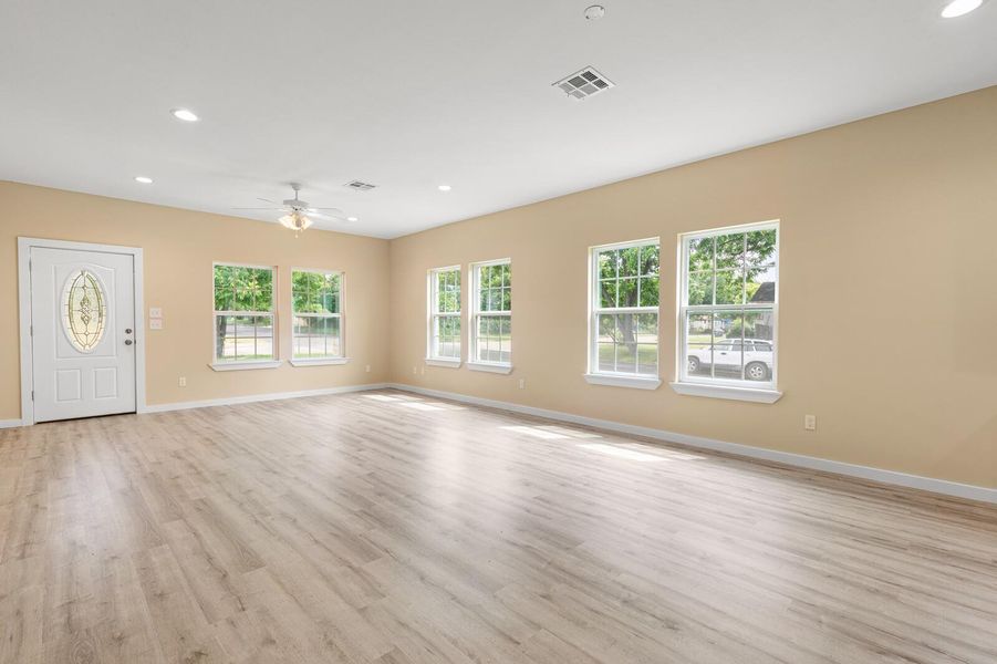 Unfurnished living room with a ceiling fan, light wood-type flooring, and recessed lighting