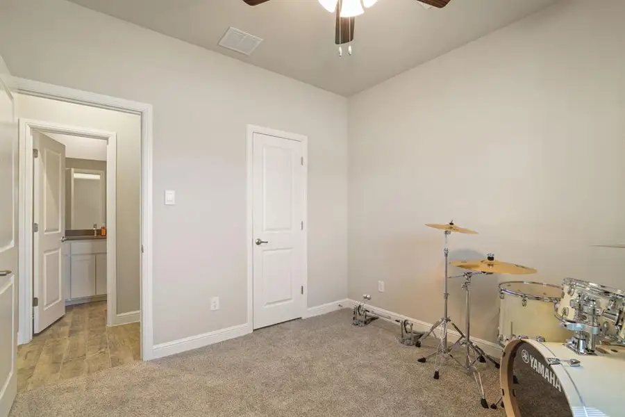 Miscellaneous room with ceiling fan and light carpet Miscellaneous room with ceiling fan and light carpet