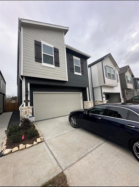 Front exterior of a new home in McClendon Park Village, Houston, TX, highlighting curb appeal (Image 1).