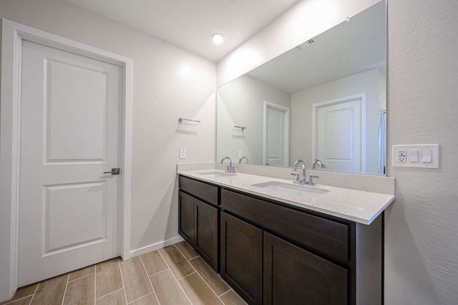 A bathroom with a large mirror. A bathroom with a large mirror.