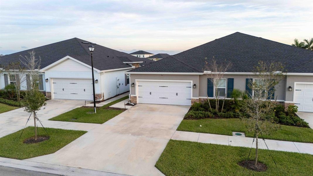 Front exterior of a new home in Central Park Villas, Port St. Lucie, FL, highlighting curb appeal (Image 2). Front exterior of a new home in Central Park Villas, Port St. Lucie, FL, highlighting curb appeal (Image 2).