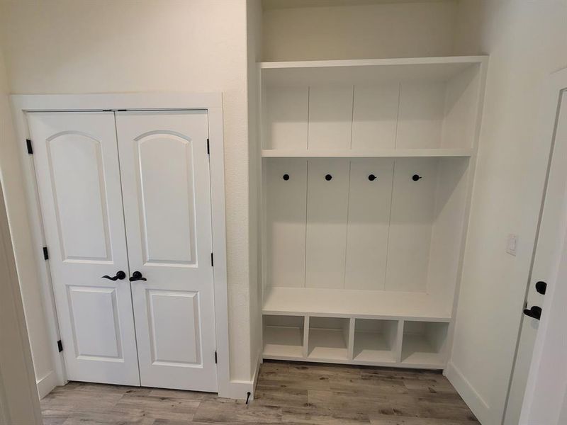 Mudroom featuring light wood-style floors