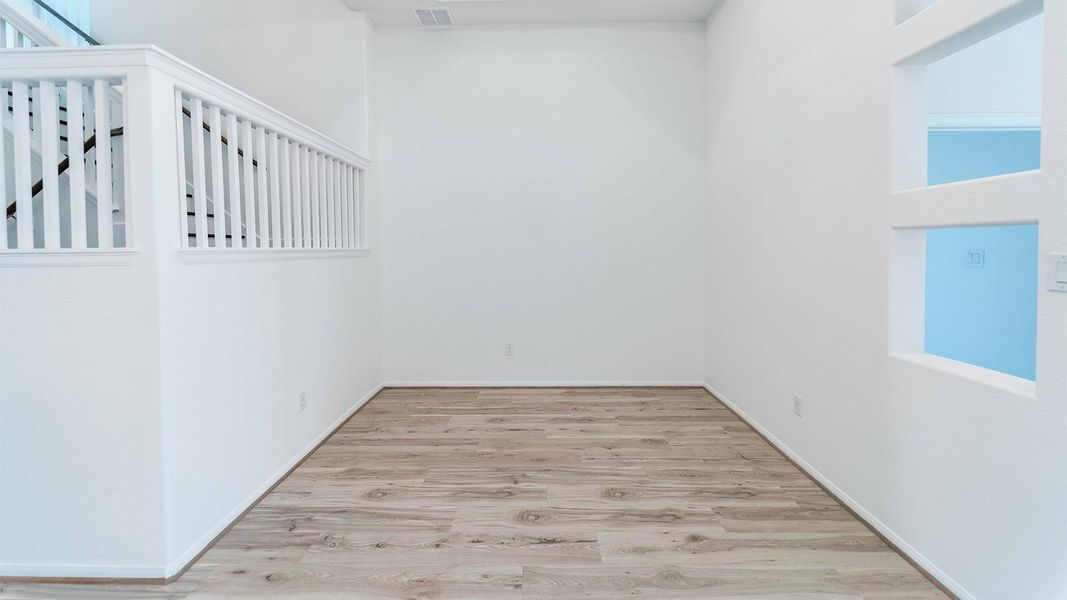 Spare room featuring light wood-style floors and baseboards