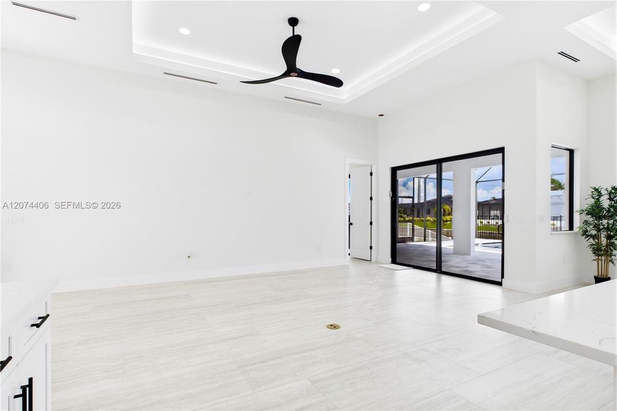 OPEN LIVING AREA showcases a dramatic DOUBLE-TRAY CEILING w/ LED ACCENT LIGHTING, sleek LINEAR A/C DIFFUSERS & contemporary statement ceiling fan. OPEN LIVING AREA showcases a dramatic DOUBLE-TRAY CEILING w/ LED ACCENT LIGHTING, sleek LINEAR A/C DIFFUSERS & contemporary statement ceiling fan.