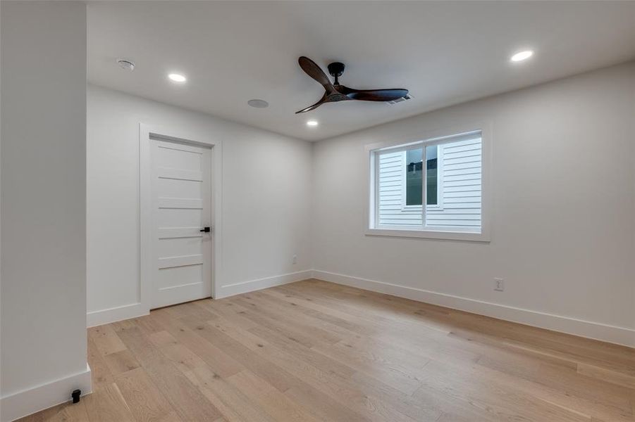 Unfurnished room with light wood-style floors, ceiling fan, and recessed lighting