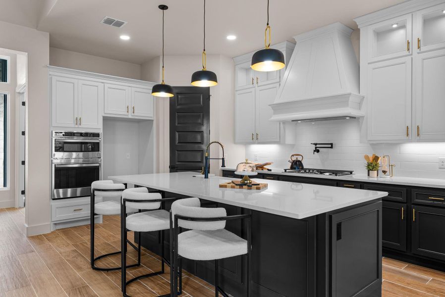 Culinary aspirations come alive in this meticulously designed kitchen, centered around a spacious island.