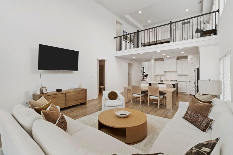 Expansive living area showcasing the high ceilings and the seamless connection to the kitchen and dining spaces. Expansive living area showcasing the high ceilings and the seamless connection to the kitchen and dining spaces.