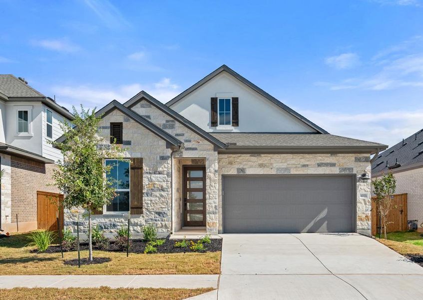 Front exterior of a new home in Arbor Collection at Heritage, Dripping Springs, TX, highlighting curb appeal (Image 2). Front exterior of a new home in Arbor Collection at Heritage, Dripping Springs, TX, highlighting curb appeal (Image 2).