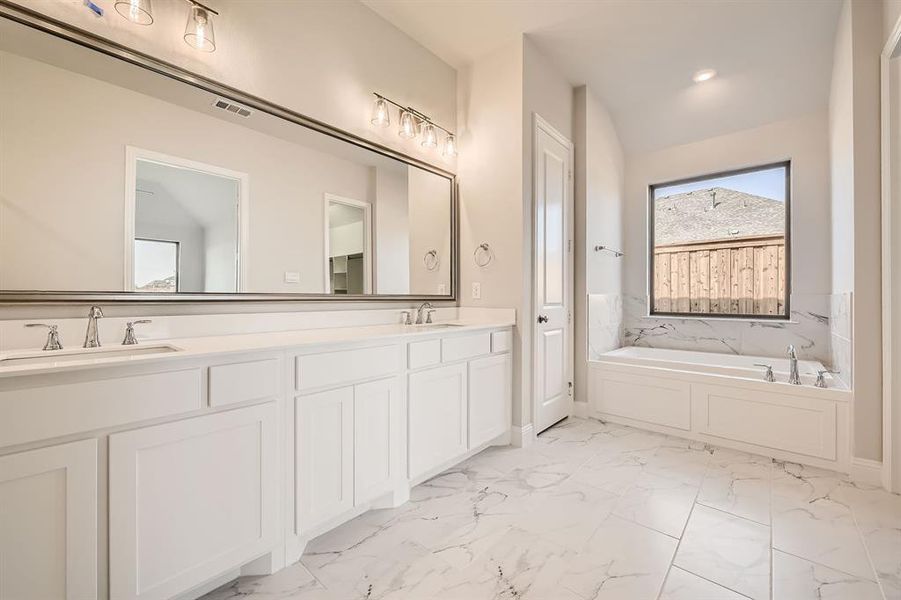 Bathroom featuring vanity and a bathtub