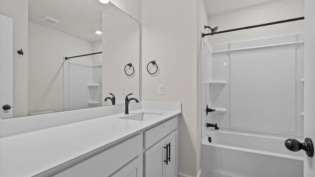 Elegant bath retreat with designer finishes and a clean, timeless aesthetic