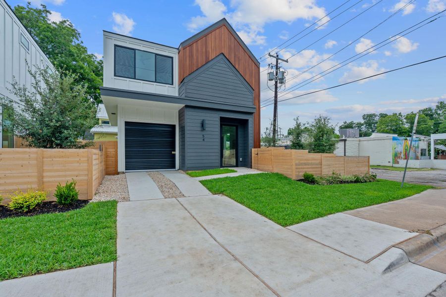Contemporary house with concrete driveway, board and batten siding, and a garage