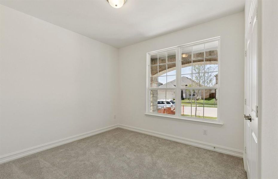 Spacious secondary bedroom features ample closet space  *Real home pictured