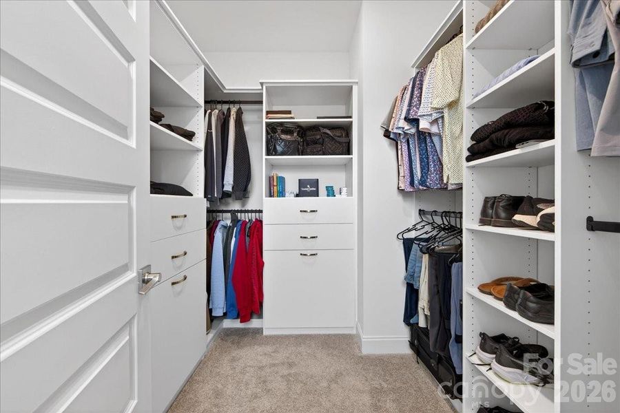 Custom built shelving in the primary closet maximizes the space.